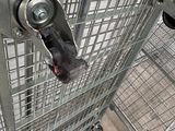 a large metal cage with wheels attached to it