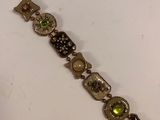a close up of a bracelet on a table with a white background