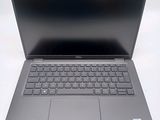 an open laptop computer sitting on top of a white table