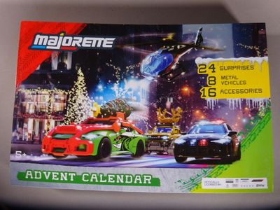 a close up of a calendar with a picture of a car and a helicopter