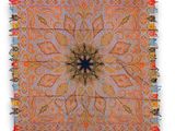 an orange and blue square rug with a star design on it