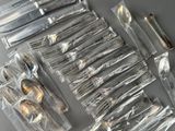 a lot of silverware that is sitting on a table