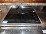 a stove top with a black burner on it