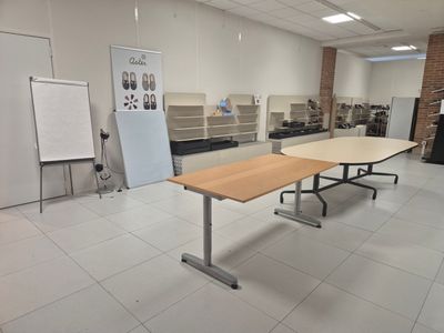 a room with a table and a whiteboard on the wall
