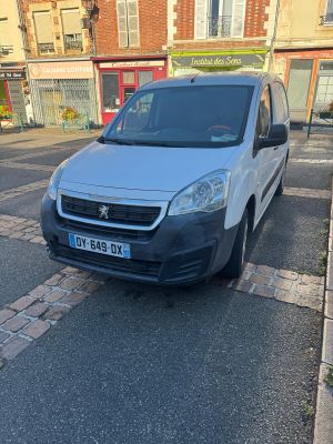 a small white van parked on the side of the street