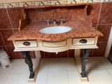 a bathroom with a marble sink and a marble counter top