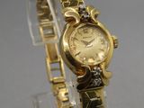 an image of a close up of a wrist watch on a clear stand