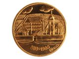 une pièce d'or sur laquelle est représentée une ville