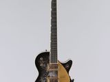 a black and gold electric guitar hanging from a ceiling
