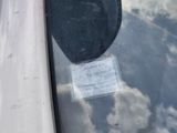 a sticker on the windshield of a car that has a sticker attached to it