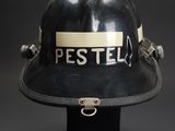 a close up of a fireman ' s helmet on a stand
