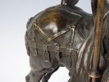 a bronze statue of a man riding a horse