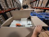 a person that is holding a box with some kind of items in it