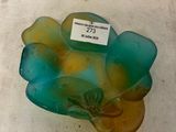 a glass bowl with a label on it sitting on a table