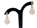 a close up of a pair of earrings on a stand