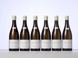 six bottles of wine are lined up on a table