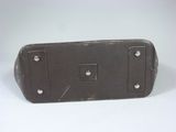 a brown leather case sitting on a white surface
