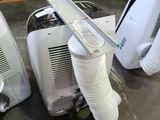 two air conditioners sitting on the floor next to each other