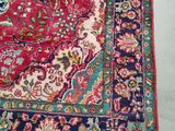 an oriental rug on a white floor with a cat sleeping on top of it