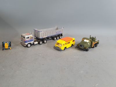 several toy trucks are lined up in a row on a gray surface