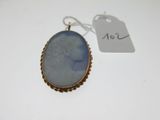 a gold and blue cameo pendant with a woman ' s face