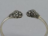 a close up of a silver ring with two lions on it