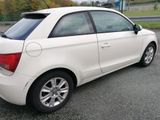 a white car that is parked on the side of the road