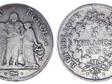 a silver coin with an image of a man and woman on it