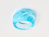 an image of a blue glass ring on a white surface