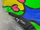 a colorful kite that is wrapped in plastic on a table