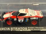 a toy car in a clear case on a table