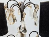 a crystal chandelier with a black shade on it