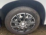 a close up of a tire on a white car