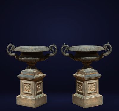 pair of antique urns on pedestals on a dark blue background