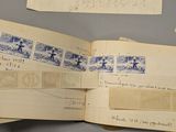 several pieces of old paper with stamps on them sitting on top of a table