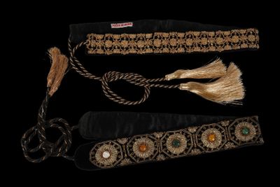 three different types of belts with tassels on a black background