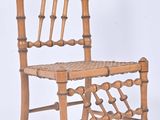 a wooden chair with a woven seat on a white background