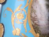 a blue vase with a picture of a woman on it