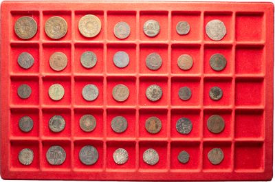an image of a red tray filled with lots of coins