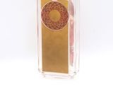 a clear box with a gold and red design on it
