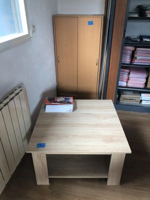 a wooden table with a book on it in a room