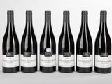 six bottles of wine are lined up in a row