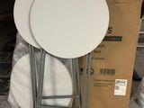 two white tables sitting on top of each other