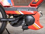 a close up of a red motorcycle parked in a garage