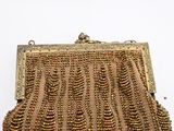 a gold purse that is sitting on a table