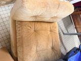 a couch and a laptop on the floor in a room