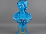 a blue busturine of a woman with a wreath on her head
