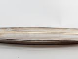 a silver plate on a white table with a white background