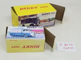 two boxes of dinky toys sitting on a table