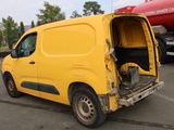 a yellow van that is parked in a parking lot